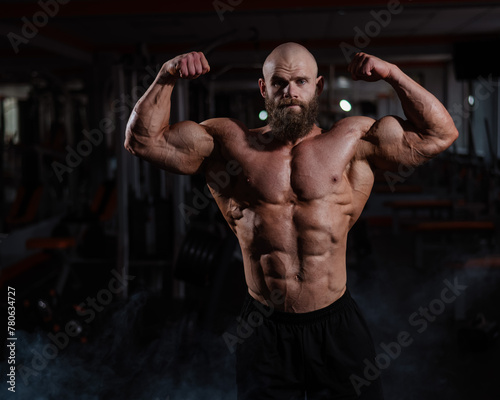 Caucasian bald man posing in the gym. © Михаил Решетников