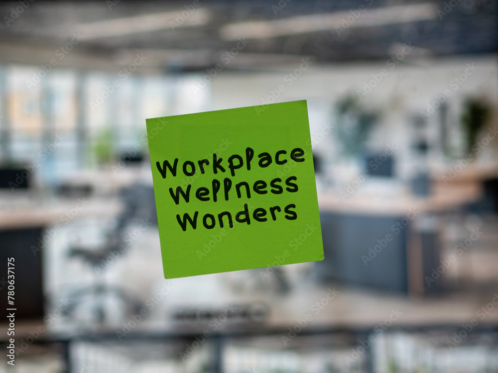 Post note on glass with 'Workplace Wellness Wonders'.