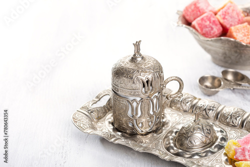 Traditional turkish coffee and turkish delight on white shabby wooden background.