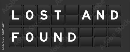 Black color analog flip board with word lost and found on gray background