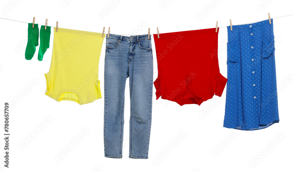 Different clothes drying on laundry line against white background