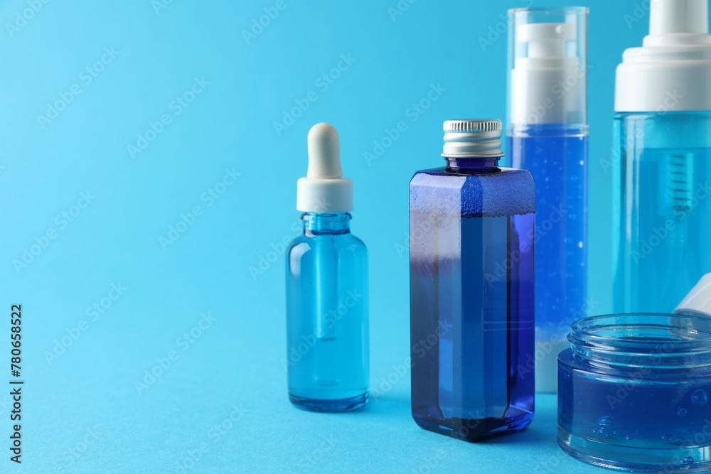 Set of luxury cosmetic products on light blue background. Space for text