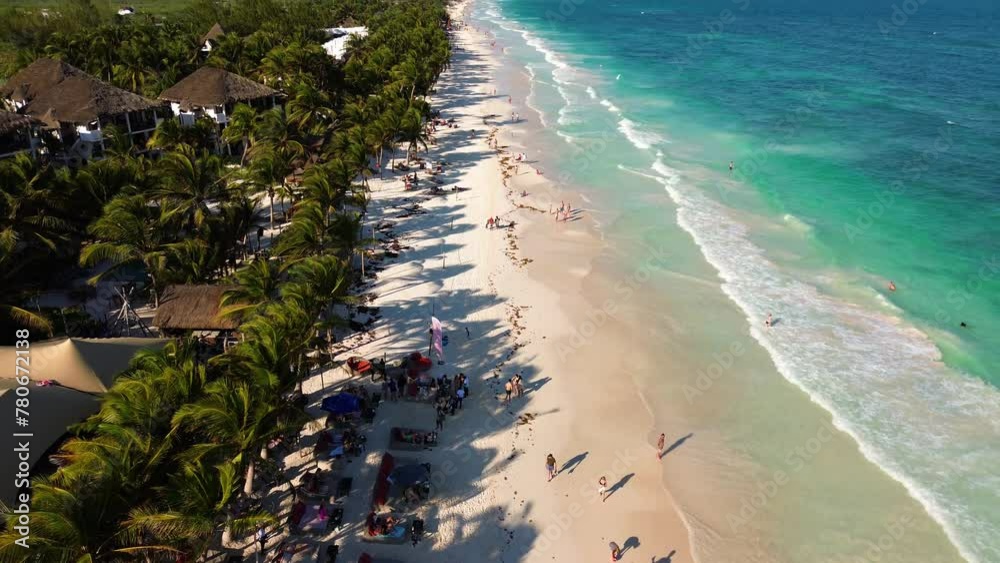 Beautiful sandy beaches in sunny Tulum in Mexico and clear blue water of the Caribbean sea close to Cancun and Playa del Carmen, a perfect vacation destination - Aerial shot drone fly by 