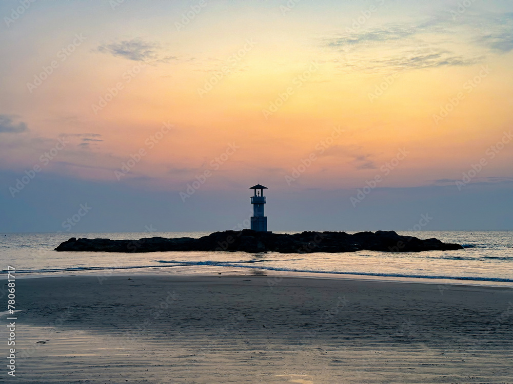 A tranquil seascape with a lighthouse silhouette against a vibrant sunset, perfect for themes of travel and nature