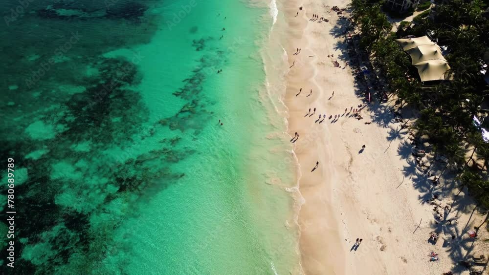 Beautiful sandy beaches in sunny Tulum in Mexico and clear blue water of the Caribbean sea close to Cancun and Playa del Carmen, a perfect vacation destination - Aerial shot drone fly by 