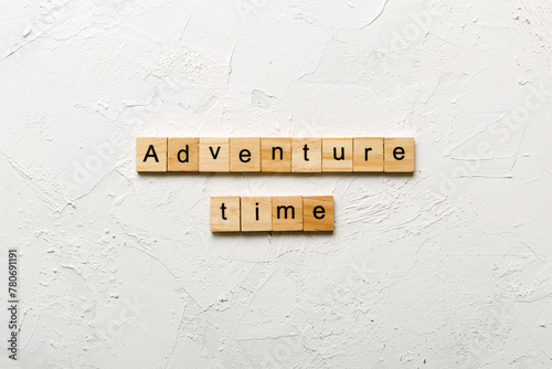 Adventure time word written on wood block. Adventure time text on cement table for your desing, concept