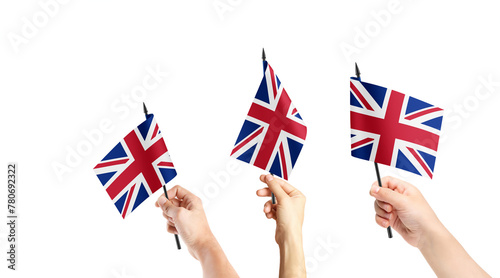 A group of people are holding small flags of United Kingdom in their hands.