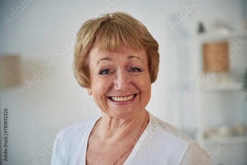 Portrait of senior elderly woman that is at home in the living room