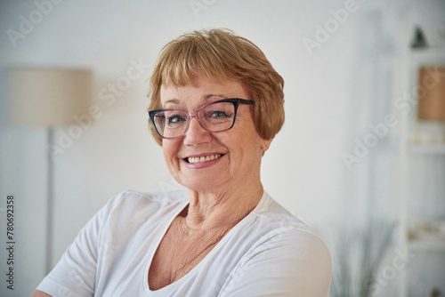 Portrait of senior elderly woman that is at home in the living room