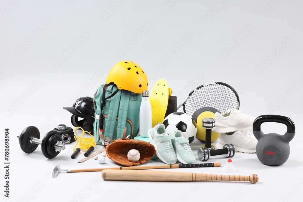 Many different sports equipment on light grey background - obrazy, fototapety, plakaty 