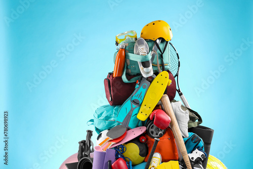 Many different sports equipment on light blue background photo