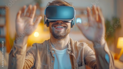 Young Caucasian man wearing VR virtual reality goggles plying in living room at home.
 photo