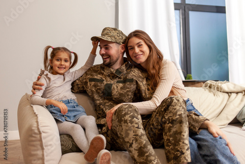 Bild auf Leinwand Ukrainian army soldier in camouflage uniform returned home to his family, milita