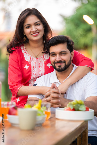 Outdoor portrait of Indian young couple together looking at camera photo