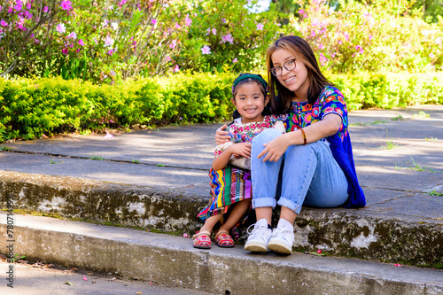 Cousins sitting on the steps of the square, taking a portrait to remember.