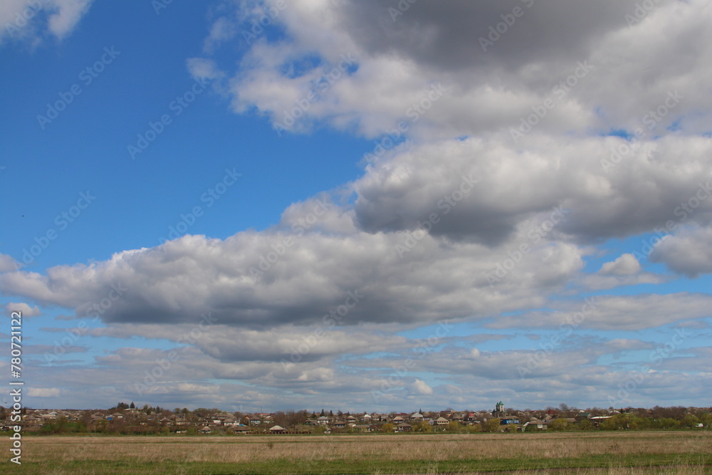 A field with clouds in the sky