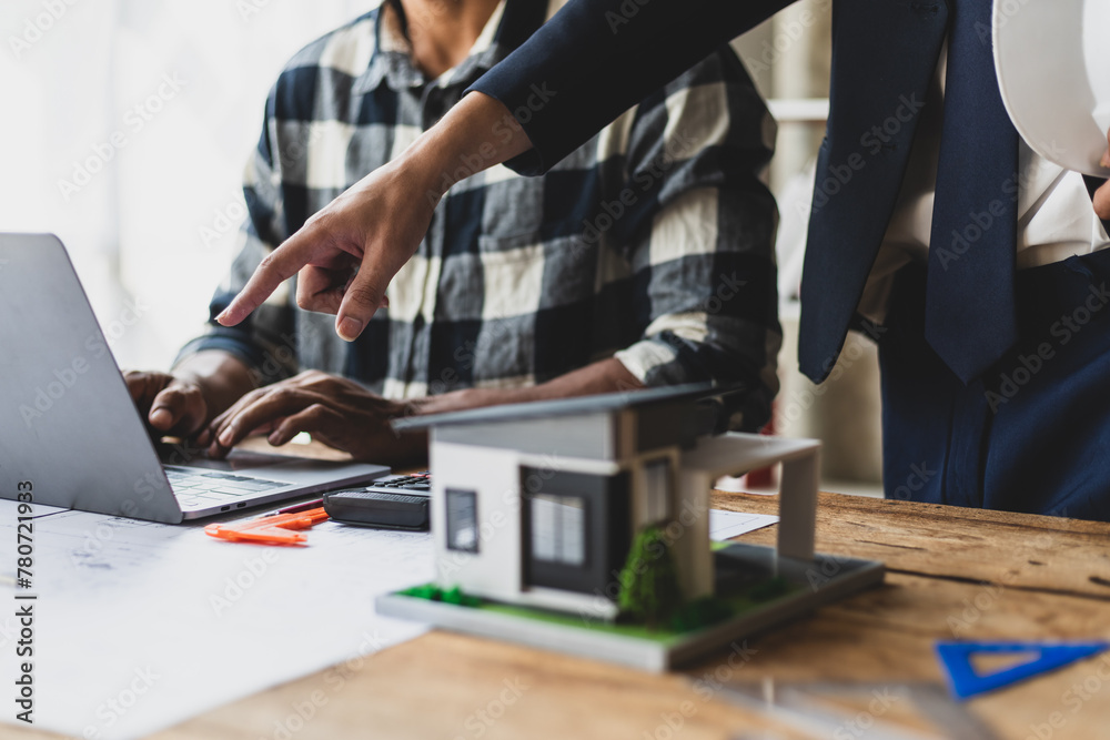 Architect and construction contractor businessman discussing design on blueprint and planning construction of real estate project. Architect and construction contractor businessman discussing design on blueprint and planning construction of real estate project.