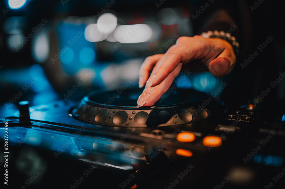 DJ skillfully manipulating a turntable in a vibrant light show, encapsulating the essence of a live music performance.