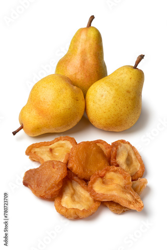 Heap of dried pear fruit and fresh pears close up isolated on white background