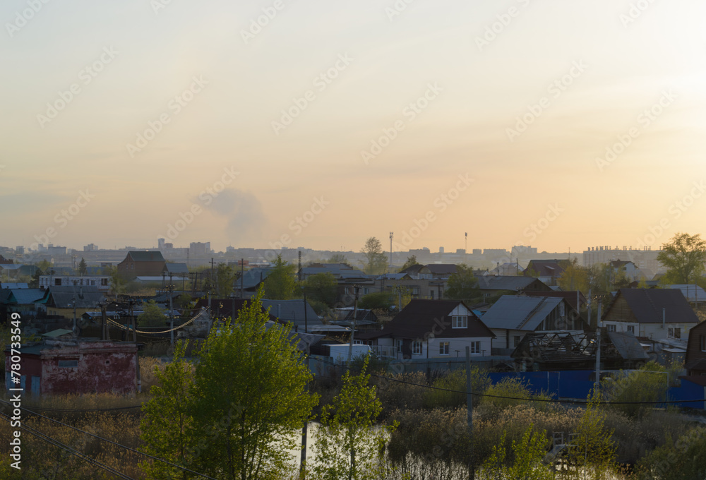 Evening landscape with village houses at sunset Evening landscape with village houses at sunset