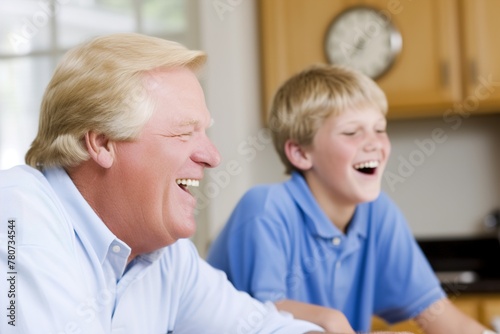 A man and a boy are laughing together