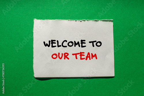 Welcome to our team words written on torn paper piece with green background. Conceptual business symbol. Copy space.