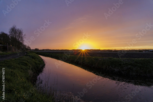 Sunset in the Netherlands on a canal near the city of Bergen