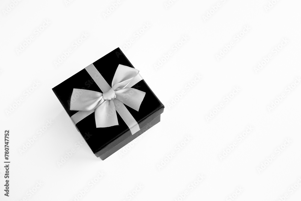 Black gift box on the white background. Top view. Copy space. Black gift box on the white background. Top view. Copy space.