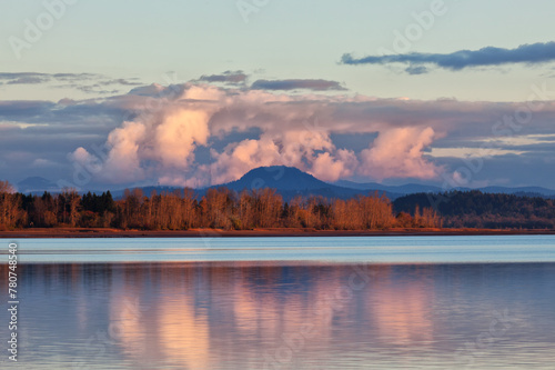 The shoreline of a lake frames Spencer Butte in the background o
