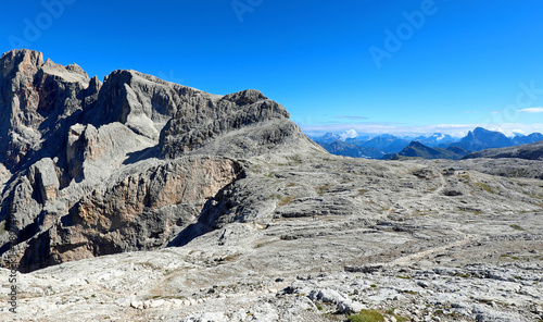 view of the European Alpine mountains with a moonscape-like scenery mountain refuge nestled among the rocks photo