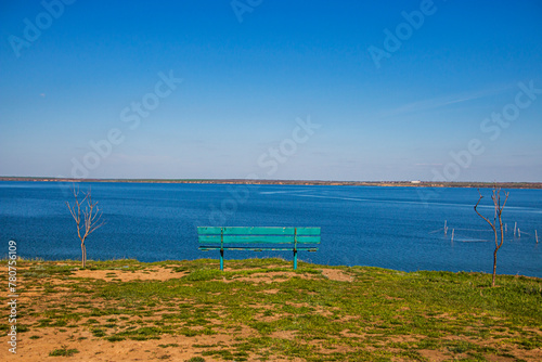 Bench on a cliff against the background of the sky and estuary