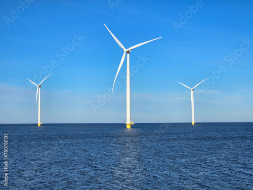 Windmill park in the ocean, drone aerial view of windmill turbines at sea in the Netherlands