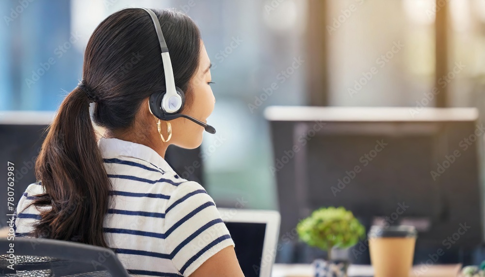 Managing the days inquiries. Rearview shot of a young woman working in a call centre Managing the days inquiries. Rearview shot of a young woman working in a call centre