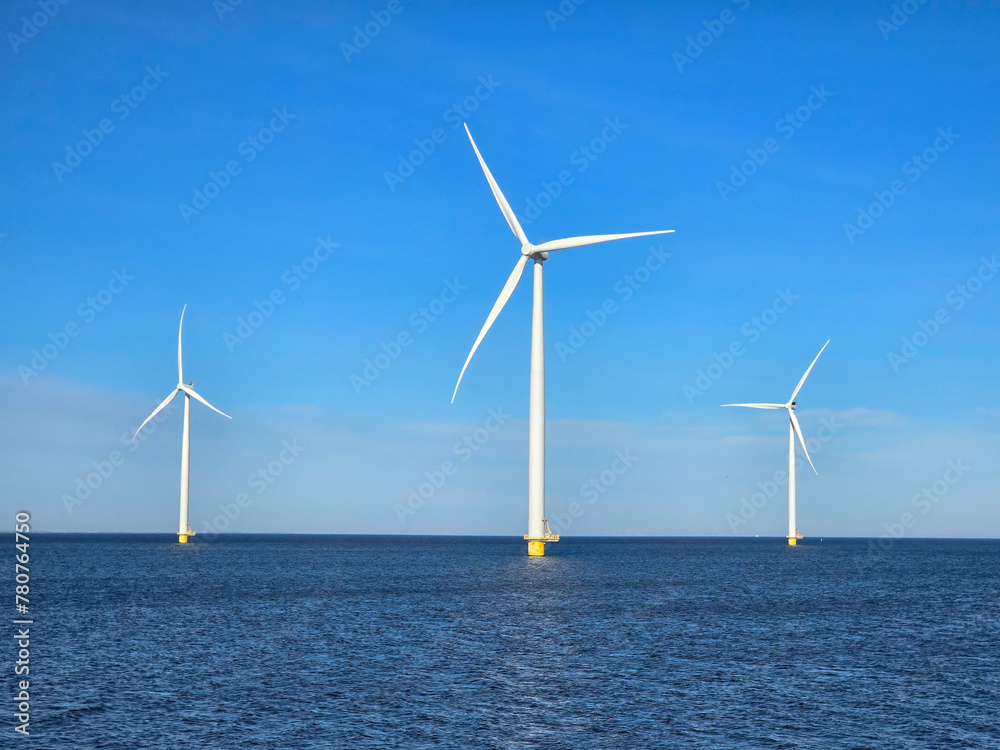 Windmill park in the ocean, drone aerial view of windmill turbines at sea in the Netherlands