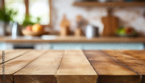 Empty wooden table for product display with blurred kitchen interior on background. © hardvicore