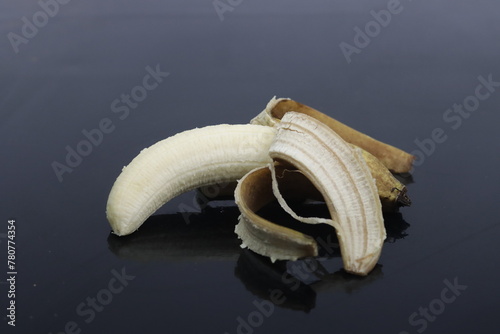peeled banana on a wooden table