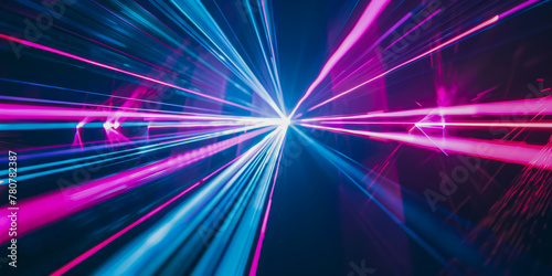 Vibrant neon blue and pink light beams converge to create the illusion of a high-speed tunnel in a dark space photo