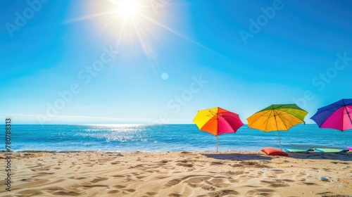 Bright sun illuminates a serene beach scene with colorful umbrellas and happy vacationers enjoying the seaside  space for text.