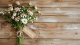 Rustic bunch of white and pink flowers on wood planks background with copy space, Happy Mother's Day written on a paper label tag
