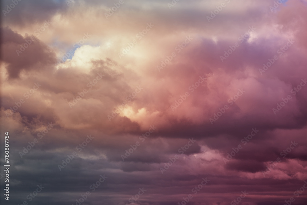 Lilac-pink clouds in the sky, evening sunlight on the clouds