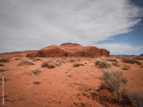 Red sandstone mesa in the middle of a sandy desert in Moab Utah