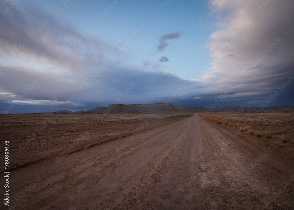 Dirt road in Green River Utah desert at sunset