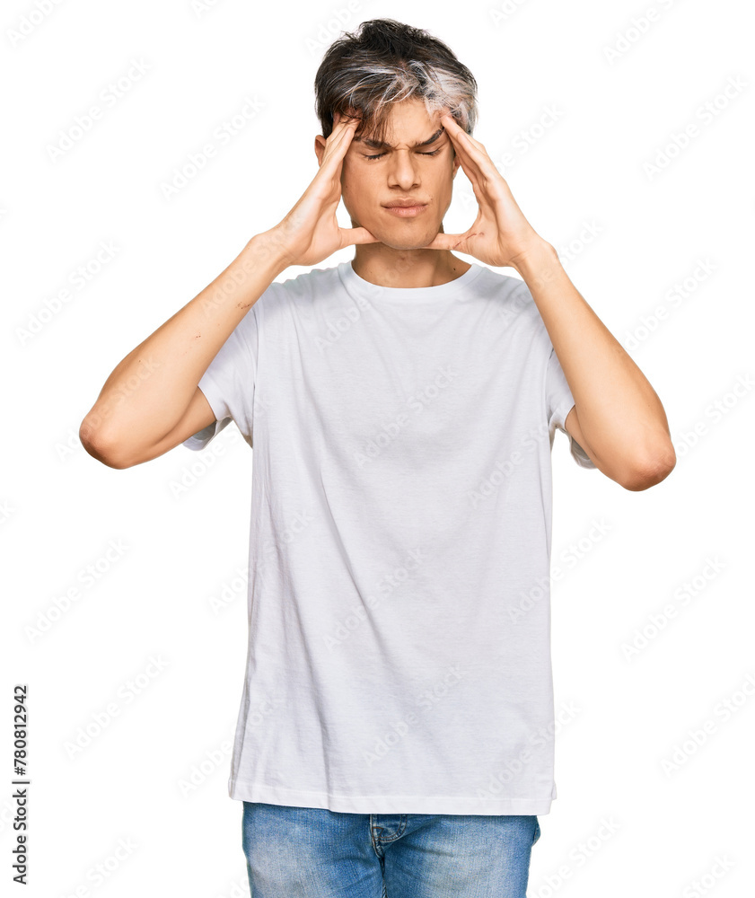 Young hispanic man wearing casual white tshirt suffering from headache desperate and stressed because pain and migraine. hands on head. Young hispanic man wearing casual white tshirt suffering from headache desperate and stressed because pain and migraine. hands on head.