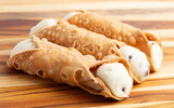 Delicious Chocolate Chip Marscapone Cheese Filled Cannoli Pastries on a Wooden Table