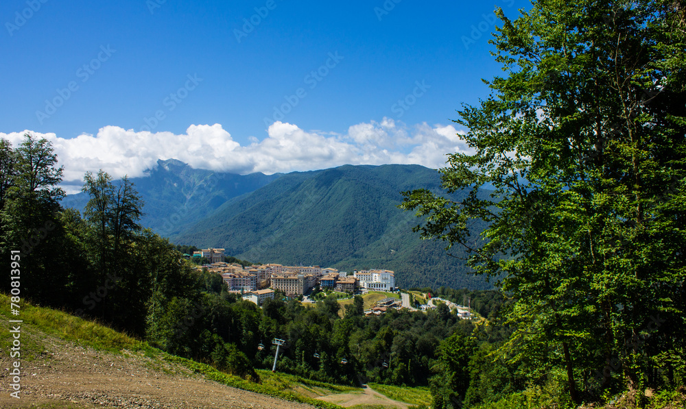 Obraz premium Beautiful panoramic landscape - view of Glade 960 with modern luxury hotels among the green mountains on a sunny summer day in Russia