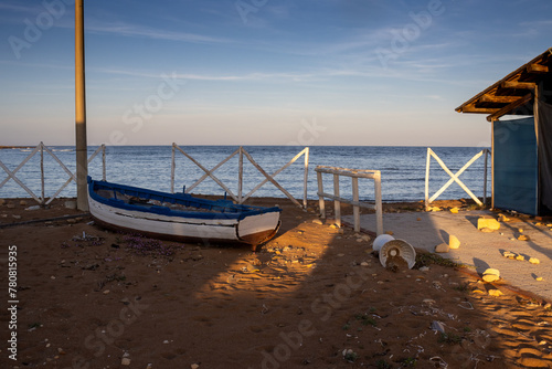 Seaside and a white fence in the morning sunlight, Sicily photo