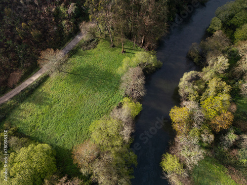 Aerial view of the Umia river as it passes through the Salnes valley in Vilanova de Arousa. Aerial view of a river surrounded by green fields and near a road in Galicia