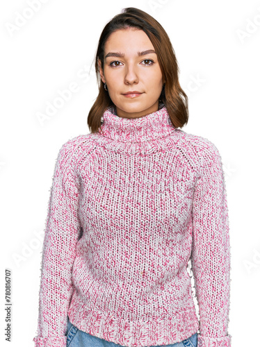 Young caucasian girl wearing wool winter sweater relaxed with serious expression on face. simple and natural looking at the camera. © Krakenimages.com
