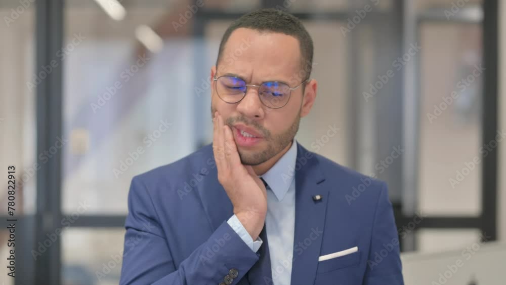 Uncomfortable Mixed Race Businessman with Toothache in Office Uncomfortable Mixed Race Businessman with Toothache in Office