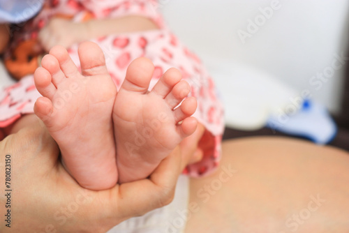 mother finger holding a child foot